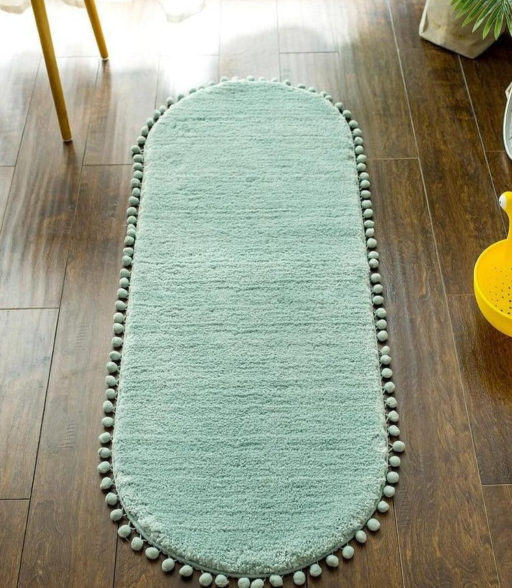 Ovaal vloerkleed met pompons en antislip
