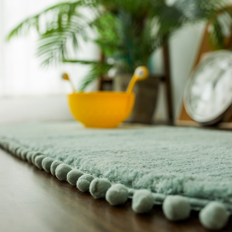 Ovaal vloerkleed met pompons en antislip