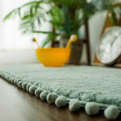 Ovaal vloerkleed met pompons en antislip