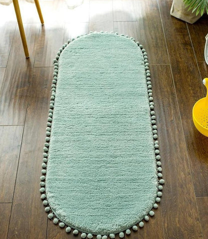 Ovaal vloerkleed met pompons en antislip