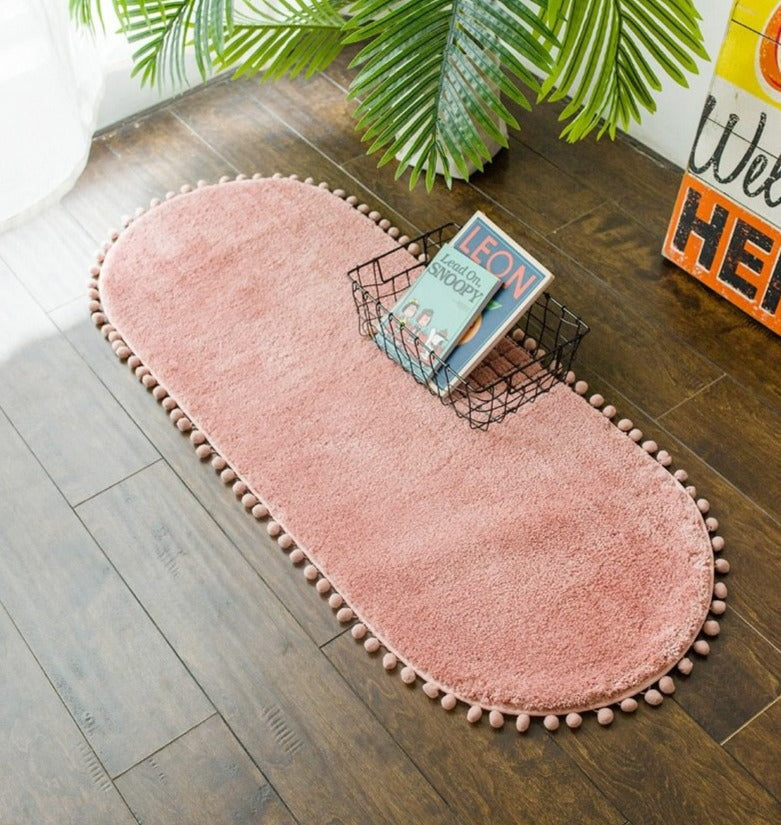 Ovaal vloerkleed met pompons en antislip