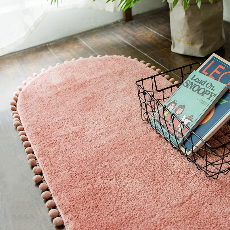 Ovaal vloerkleed met pompons en antislip