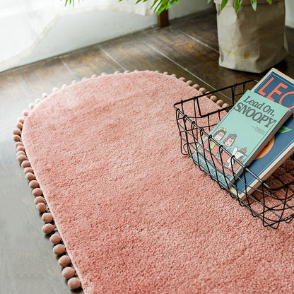 Ovaal vloerkleed met pompons en antislip