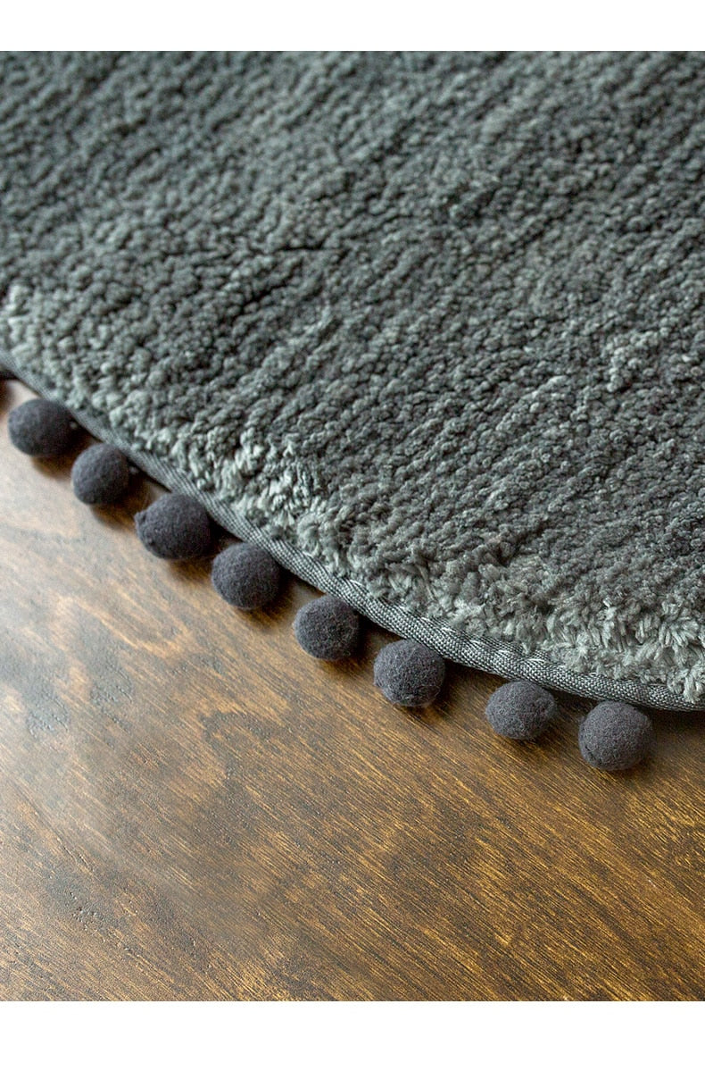 Ovaal vloerkleed met pompons en antislip