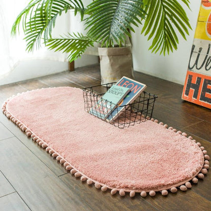 Ovaal vloerkleed met pompons en antislip